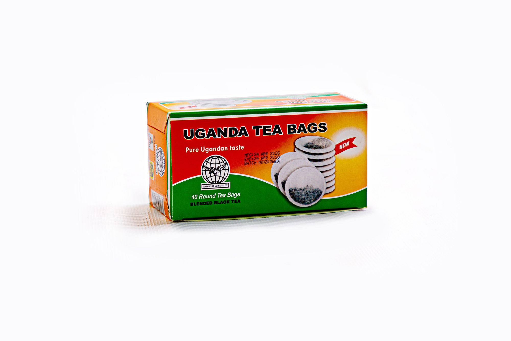 Uganda Tea Bags Round — 40 tagless round tea bags shown stacked beside the green-and-red retail box